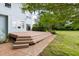 An exterior view of the home's backyard featuring a wood deck and brick paver at 59 Troy Dr, Fuquay Varina, NC 27526