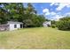 This backyard features a chicken coop and lush green lawn at 59 Troy Dr, Fuquay Varina, NC 27526