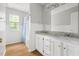 Bathroom featuring a dual sink vanity with granite countertops and white cabinets, creating a clean and elegant space at 59 Troy Dr, Fuquay Varina, NC 27526