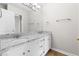 Bathroom featuring a dual sink vanity with granite countertops and white cabinets, creating a clean and elegant space at 59 Troy Dr, Fuquay Varina, NC 27526