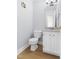 Cozy powder room with a granite vanity and white wooden cabinets at 59 Troy Dr, Fuquay Varina, NC 27526