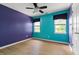 Bedroom showcasing vibrant walls, bright windows and wood floors creating a modern and stylish living space at 59 Troy Dr, Fuquay Varina, NC 27526
