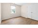 Bedroom featuring wood floors, bright window, and closet, offering style and convenience in a compact space at 59 Troy Dr, Fuquay Varina, NC 27526