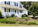 Charming front porch with a white railing and decorative plants, leading to the main entrance at 59 Troy Dr, Fuquay Varina, NC 27526