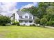 Inviting two-story home with a well-manicured lawn and charming front porch, perfect for relaxing outdoors at 59 Troy Dr, Fuquay Varina, NC 27526