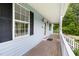 Detailed view of the side of the porch, showcasing its wooden flooring and white railing at 59 Troy Dr, Fuquay Varina, NC 27526