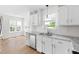 Beautiful kitchen with white cabinets, granite countertops, stainless steel appliances, and large windows at 59 Troy Dr, Fuquay Varina, NC 27526