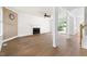 Spacious living room with hardwood floors, a fireplace, and natural light from large windows at 59 Troy Dr, Fuquay Varina, NC 27526