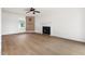 Open-concept living room with hardwood floors, a fireplace, and ample space for furniture and decor at 59 Troy Dr, Fuquay Varina, NC 27526
