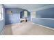 Versatile room with blue walls, carpet and bright window, offering potential for an office or hobby area at 59 Troy Dr, Fuquay Varina, NC 27526