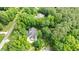 Drone view showing the house nestled amongst mature trees and landscaping at 5916 Two Pines Trl, Wake Forest, NC 27587