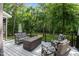 Outdoor deck featuring a seating area with comfortable furniture and lush landscaping at 5916 Two Pines Trl, Wake Forest, NC 27587