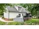 View of the back of the house showing the deck with table and chairs and steps down to the yard at 5916 Two Pines Trl, Wake Forest, NC 27587