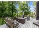 Outdoor deck featuring a seating area with comfortable furniture and lush landscaping at 5916 Two Pines Trl, Wake Forest, NC 27587