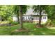 Backyard view showcasing the deck, screened-in porch, mature trees, and tree swing at 5916 Two Pines Trl, Wake Forest, NC 27587