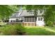 Beautiful backyard with a spacious deck, screened porch, and lush green lawn, perfect for outdoor enjoyment at 5916 Two Pines Trl, Wake Forest, NC 27587