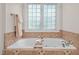 Bathroom with a large soaking tub next to a window at 5916 Two Pines Trl, Wake Forest, NC 27587