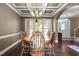 Charming dining room with coffered ceilings, hardwood floors, bright windows, and a classic wooden table at 5916 Two Pines Trl, Wake Forest, NC 27587