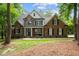 Stunning brick home with stone accents, dormer window, a welcoming porch and beautifully landscaped front yard at 5916 Two Pines Trl, Wake Forest, NC 27587