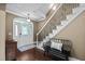 Welcoming foyer with elegant staircase, decorative front door, hardwood floors and bench seating at 5916 Two Pines Trl, Wake Forest, NC 27587