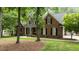 Charming two-story brick home with black shutters, a well-manicured lawn, and mature trees at 5916 Two Pines Trl, Wake Forest, NC 27587