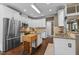 Bright kitchen featuring granite counters, stainless steel appliances, and a butcher block island at 5916 Two Pines Trl, Wake Forest, NC 27587