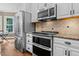 Stainless steel appliances, granite countertops, and white cabinets highlight this kitchen at 5916 Two Pines Trl, Wake Forest, NC 27587
