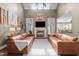 Bright, open living room with vaulted ceilings, fireplace, hardwood floors, and comfortable leather seating at 5916 Two Pines Trl, Wake Forest, NC 27587
