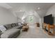 Comfortable living room with a large sectional sofa, modern entertainment center, and a window seat with natural lighting at 5916 Two Pines Trl, Wake Forest, NC 27587