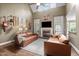Cozy living room featuring a fireplace, vaulted ceilings, and comfortable seating with decoratively displayed guitars at 5916 Two Pines Trl, Wake Forest, NC 27587