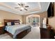 Spacious main bedroom features tray ceilings, a fan, and a connected office area at 5916 Two Pines Trl, Wake Forest, NC 27587