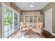 Cozy sunroom filled with light, neutral furniture, and views of the outdoor deck at 5916 Two Pines Trl, Wake Forest, NC 27587