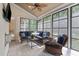 Bright sunroom filled with natural light, wicker furniture, and views of the outdoors at 5916 Two Pines Trl, Wake Forest, NC 27587