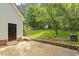 The backyard features green grass, garden beds and a detached garage at 669 Tyler Run Dr, Wake Forest, NC 27587