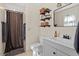 Charming bathroom with a shower and patterned curtain, modern sink with storage, and decorative shelving at 669 Tyler Run Dr, Wake Forest, NC 27587
