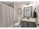 Neutral bathroom featuring a tub with shower, framed mirror, and stylish vanity with cabinet storage at 669 Tyler Run Dr, Wake Forest, NC 27587