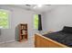 Cozy bedroom featuring a bed, windows, and a bookshelf at 669 Tyler Run Dr, Wake Forest, NC 27587