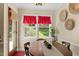 Bright dining area with a large window and decorative wall art and decor at 669 Tyler Run Dr, Wake Forest, NC 27587