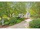 Traditional home with a lush front yard, inviting driveway, and mature trees at 669 Tyler Run Dr, Wake Forest, NC 27587