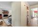 Inviting hallway with hardwood floors leading to a living room with a brick fireplace and a dining area at 669 Tyler Run Dr, Wake Forest, NC 27587