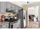 Stylish kitchen featuring gray cabinets, granite countertops and stainless steel appliances at 669 Tyler Run Dr, Wake Forest, NC 27587