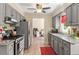 Open-concept kitchen featuring gray cabinets, granite countertops, and stainless appliances at 669 Tyler Run Dr, Wake Forest, NC 27587