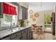 Well-lit kitchen area showcasing granite countertops and a view to the front porch at 669 Tyler Run Dr, Wake Forest, NC 27587