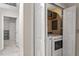 Convenient laundry room featuring a washer and dryer with storage shelves, neatly tucked away with closet doors at 669 Tyler Run Dr, Wake Forest, NC 27587