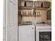 Functional laundry space featuring a washer and dryer with overhead storage, maximizing utility and organization at 669 Tyler Run Dr, Wake Forest, NC 27587