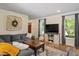 Inviting living room features stylish furniture, a large TV, and natural light from the windows at 669 Tyler Run Dr, Wake Forest, NC 27587