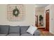 Comfortable living room featuring a gray sofa with a decorative basket weave and view of the stairs at 669 Tyler Run Dr, Wake Forest, NC 27587