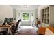 Bright office space featuring a large window, desk, chair, and hardwood flooring at 669 Tyler Run Dr, Wake Forest, NC 27587