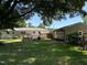 Spacious backyard featuring a wooden deck, swing, and mature trees providing ample shade at 704 S Mineral Springs Rd, Durham, NC 27703