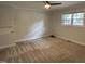Neutral bedroom with carpeting, a window, and built in shelves at 704 S Mineral Springs Rd, Durham, NC 27703